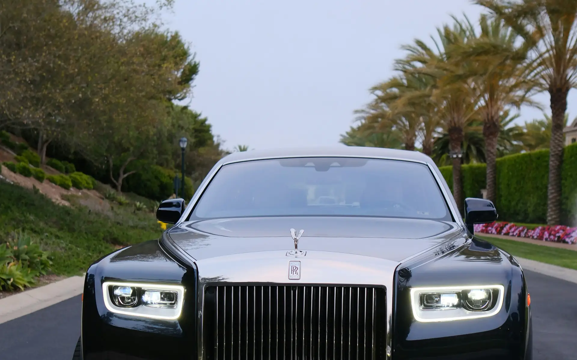 Black Rolls-Royce luxury wedding car with headlights on