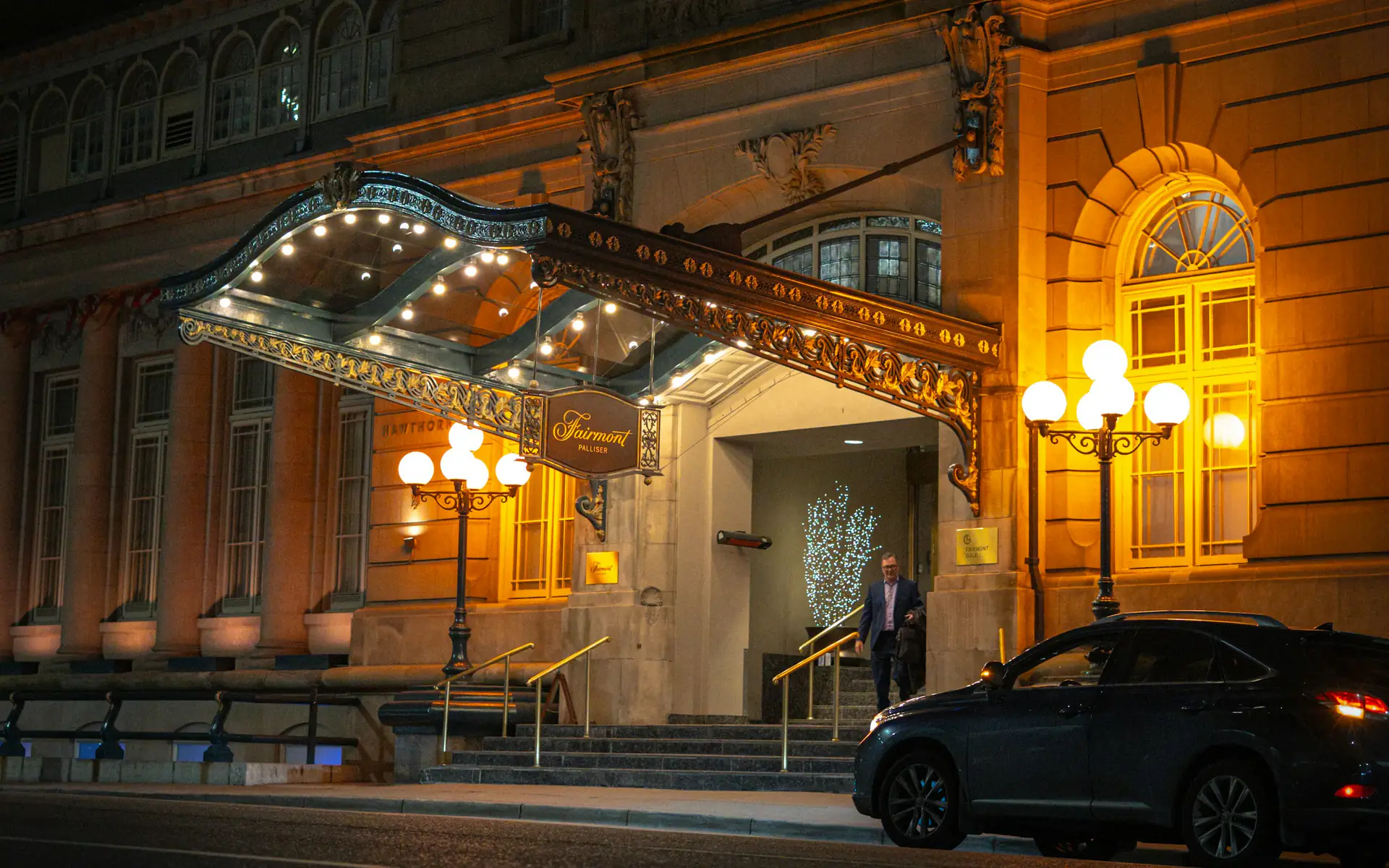 Grand hotel entrance with a lit canopy at night