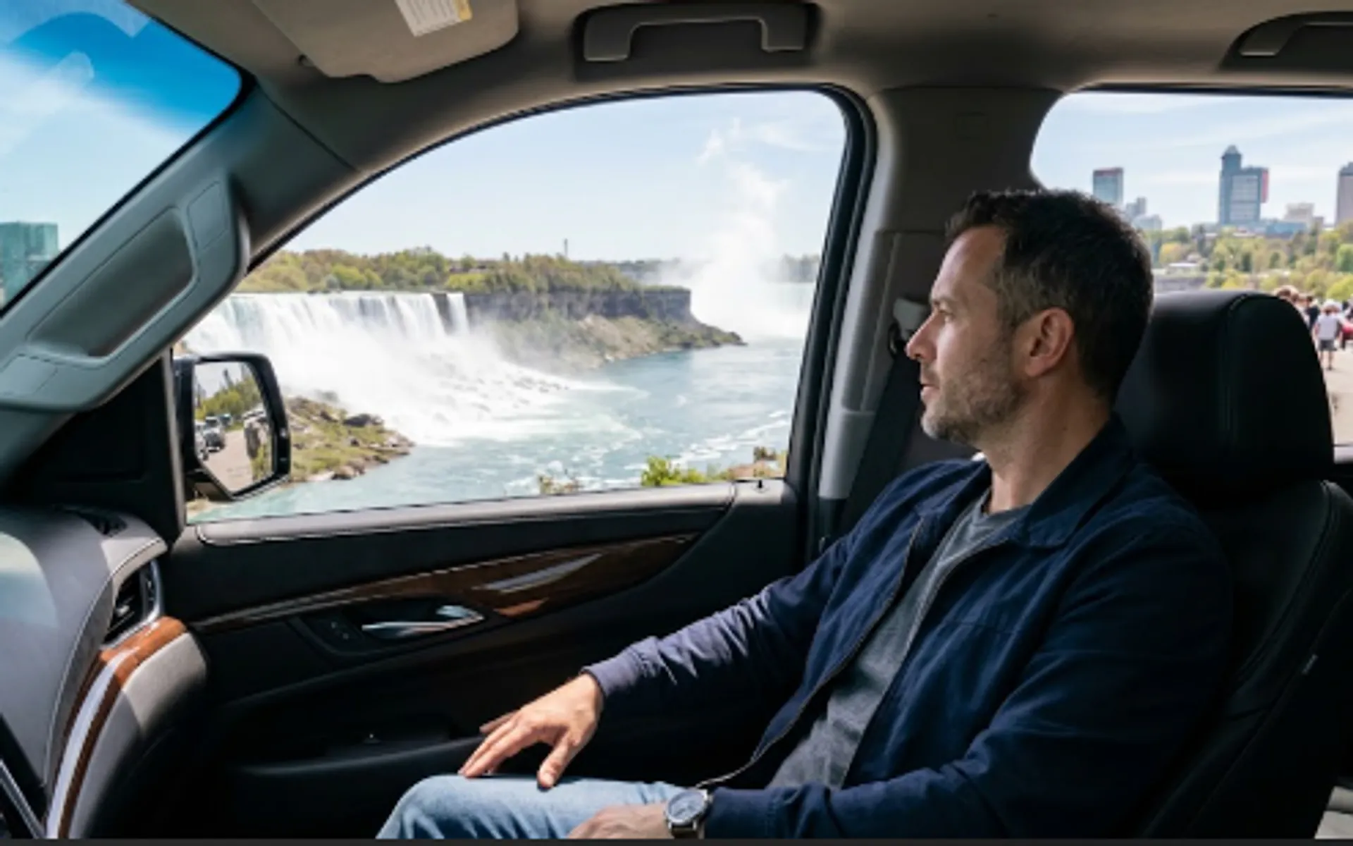 Passenger in a luxury SUV enjoying the view of Niagara Falls on a chauffeured day trip